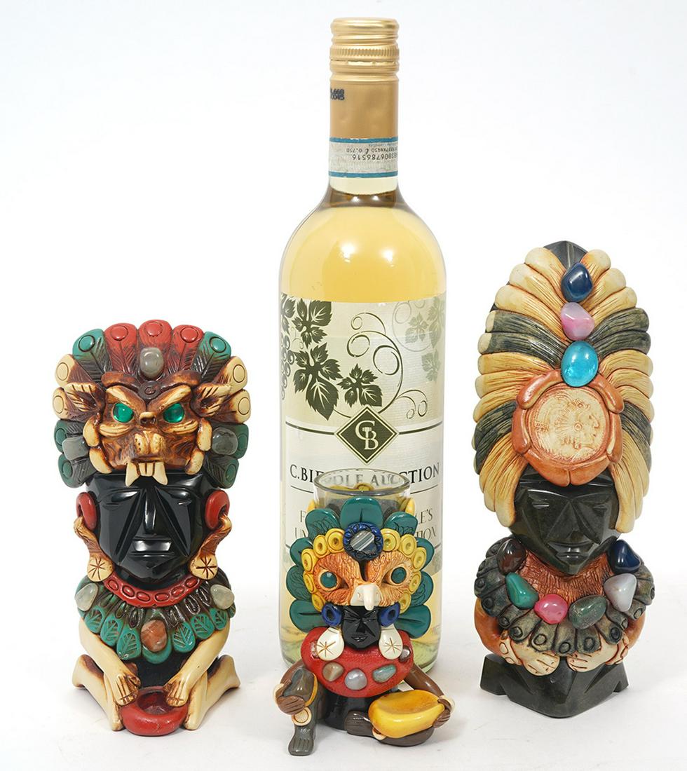 3 Carved Warriors Obsidian & Semi-Precious Stones: 3 colorful carved obsidian warrior god figuriness with elaborate headdresses and decorated with semi-precious stones, 1 with a glass center marked 'Cabo San Lucas' on verso. Measures 7.75"H x 3"W; 6.5