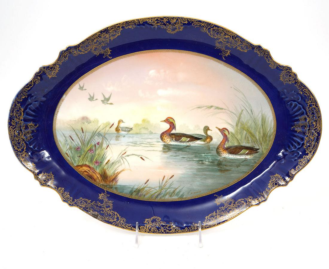 Theodore Haviland Limoges France Platter: Theodore Haviland Limoges France oval platter with scalloped gilt rim on cobalt. Hand painted center scene of ducks in a pond. Measures 18"L x 13"W. Condition report: good condition, please see photos