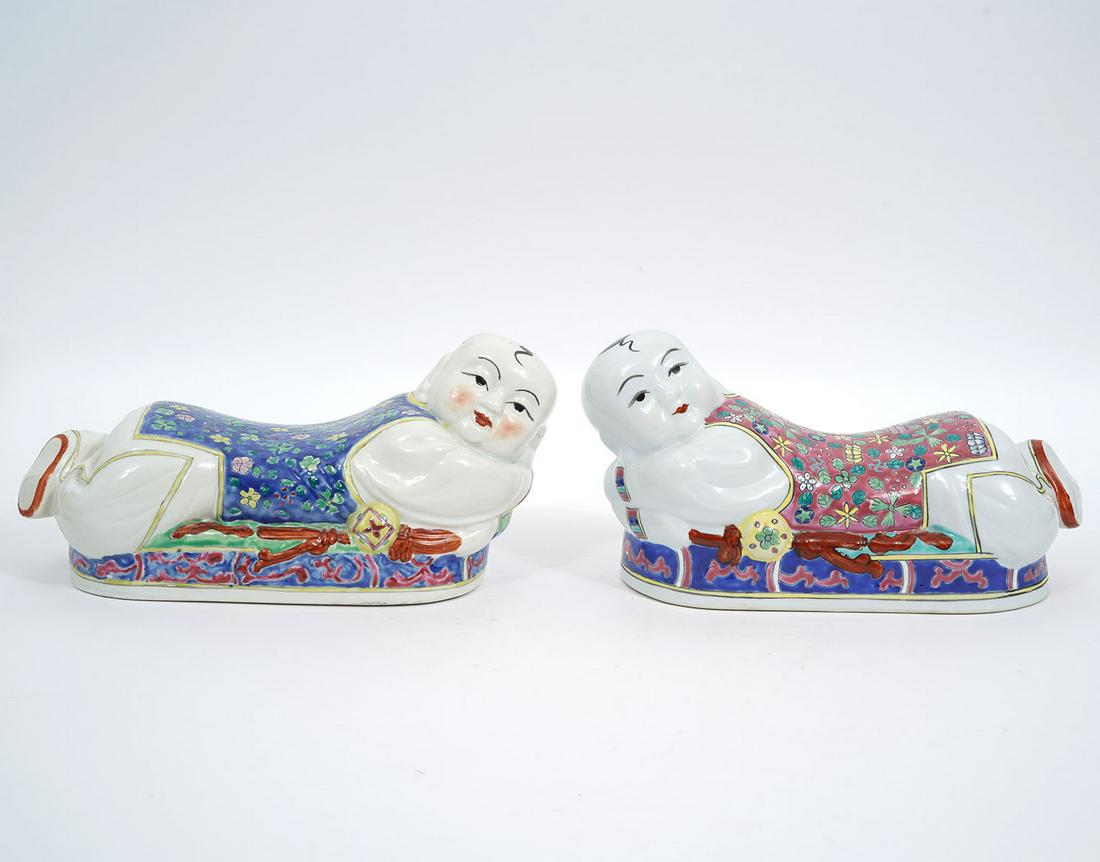 Pr. Chinese Famille Rose Porcelain Pillows Signed: Pair of Chinese Famille Rose porcelain pillow figural forms of kneeling child. Signed with red four character mark underside. Measures 11.5"L x 5"W x 5.5"H. Condition report: Good condition, no issues