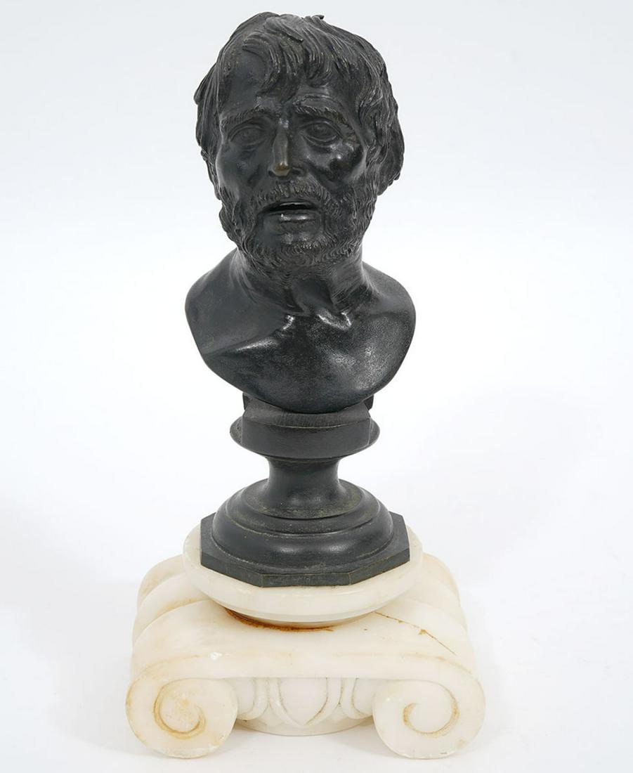 Grand Tour Seneca Bust on White Marble: Grand Tour bronze bust of the philosopher Seneca, sits in wood rod mounted carved scroll pedestal base. Measures 4"L x 3"W x 8"H. Condition report: Crack and chips to marble base, please examine all p