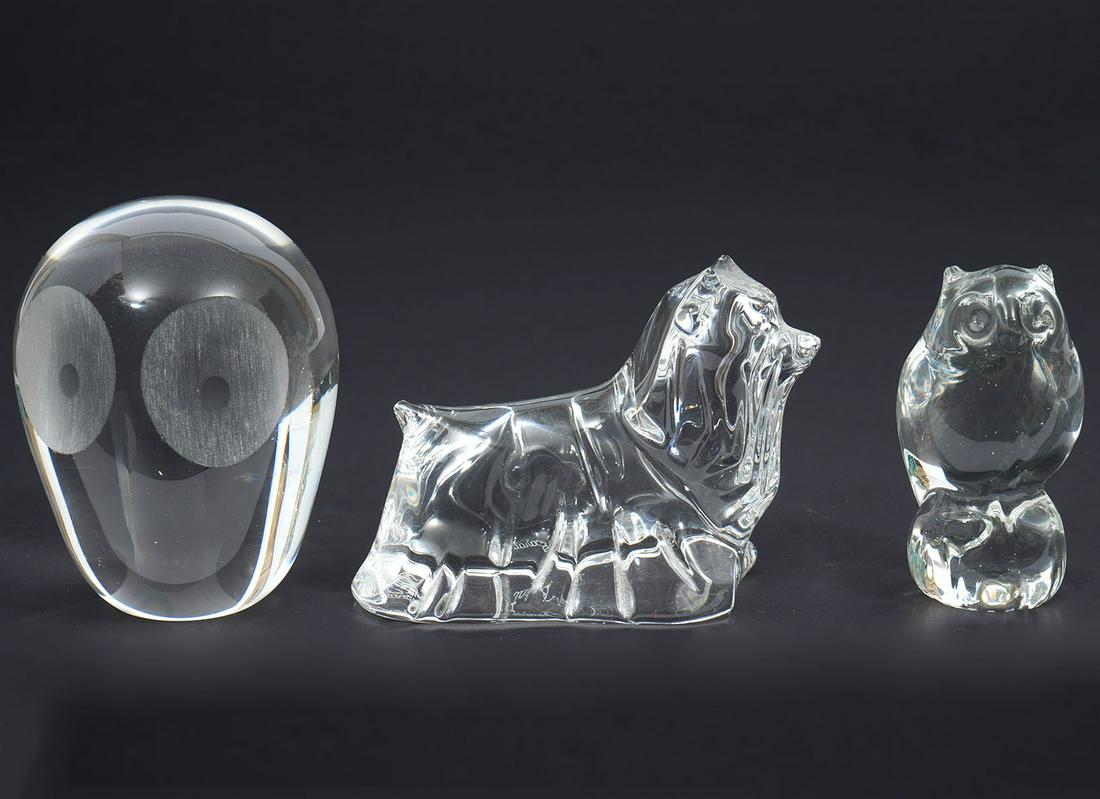 Lot of Three Crystal Animals: Baccarat Yorkshire terrier figure (4"L x 2"W x 3"H); Owl with large frosted eyes, unsigned (4"H x 3"W); Clear perched owl, unsigned (3"H x 1.75"W). Condition report: Owl has chips to ears, please exam