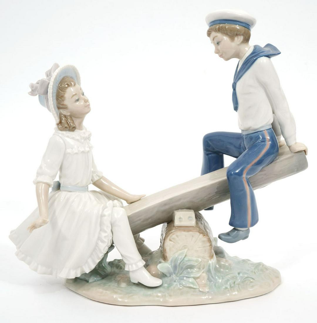Lladro "See-Saw" Porcelain Figurine: Lladro "See-Saw" porcelain figurine, #1255. Features young lady and sailor playing on see-saw. Measures 10.5"L x 4.5"W x 9.75"H. Condition report: Good condition, no issues, please examine all photos 