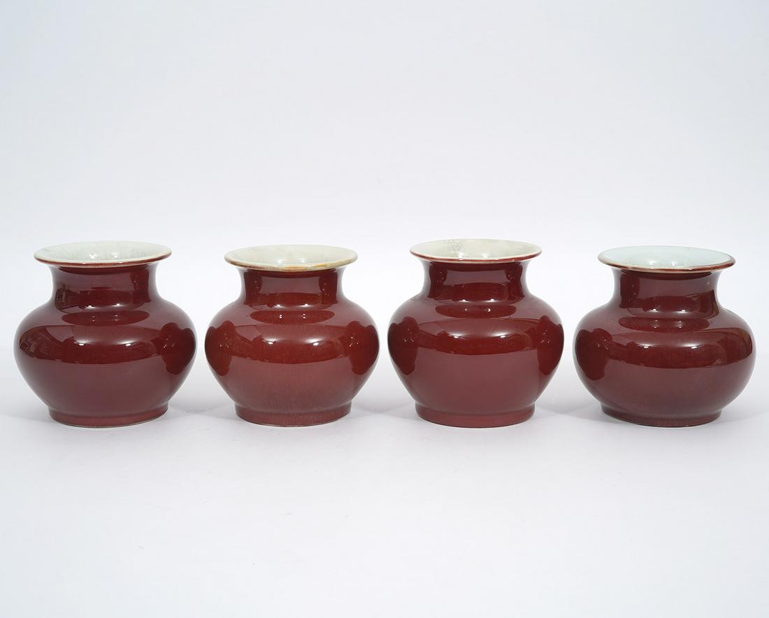 4 Chinese Sang de Boeuf Glazed Stout Vases: 4 Chinese Sang de Boeuf glazed stout vases with flared rims and white crackle interiors, bulbous form. Measures 4.75"H x 5"W. Condition report: good condition, please see all photos. Contact C. Biddle