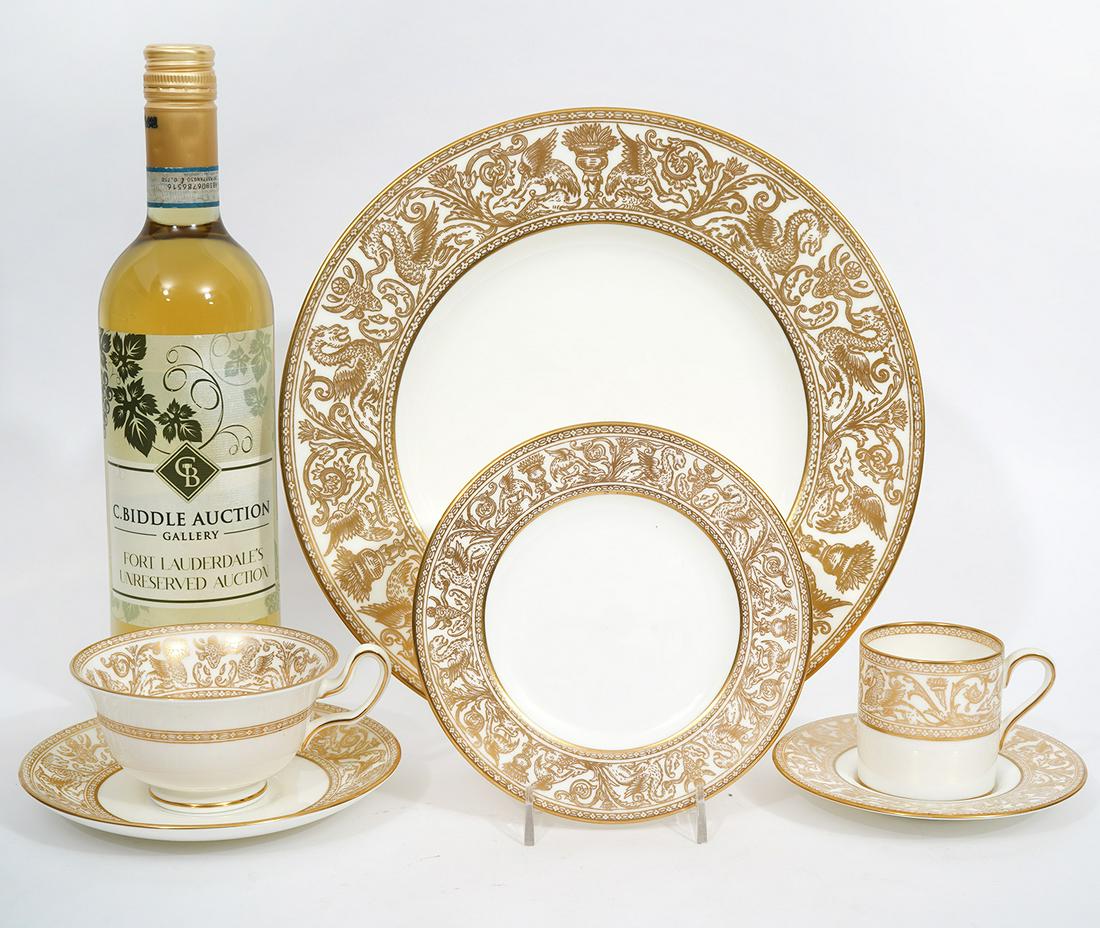 27 Pcs. Wedgwood "Gold Florentine": Wedgwood "Gold Florentine" pattern, featuring repeating gilt pattern of griffins and classical elements. Includes: 6 dinner plates (10"), 6 demitasse cups (2"H x 3"W) and 4 saucers (5.25"), 5 tea cups