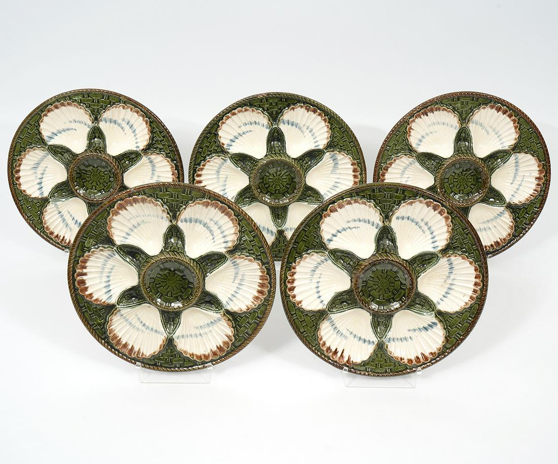 5 Longchamp French Majolica Oyster Plates: Group of 5 French majolica oyster plates, each features six shell shaped sections. Underside stamped "Longchamp Terre de fer". Each measure 9.75" diameter. Condition report: Chips to edges throughout,