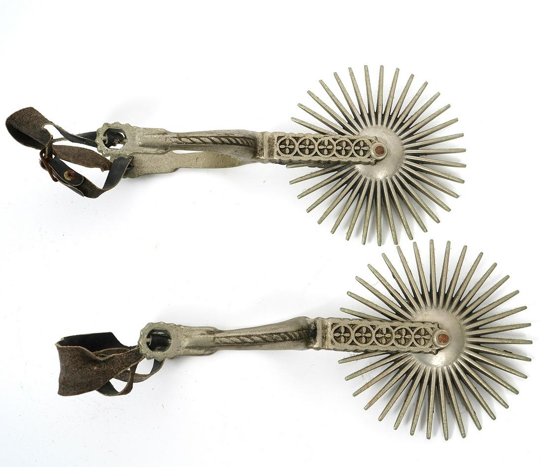 Pair of Chilean Hauso White Metal Spurs: Pair of Chilean Hauso white metal spurs features large rowels, finely crafted with embellished arms and wheel boxes. Measures 9.5"L x 5"W. Condition report: Common wear for age and use, please examine