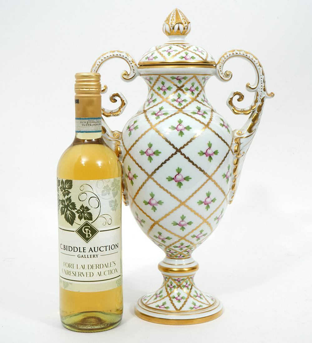 Herend 'Sevres Roses' Gilt Porcelain Urn: Herend Hugarian 'Sevres Roses' pattern gilt porcelain scroll handled urn. Decoration has pink roses in repeating crossed gold pattern. Hallmarked underside. Measures 14.5"H x 9"W. Condition report: Go