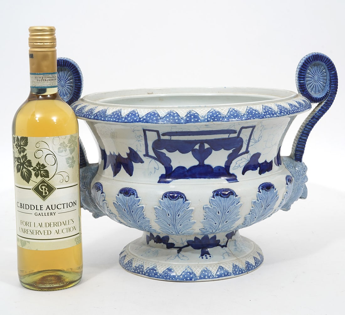 English Mason's Blue & White Centerpiece: English Mason's blue & white stone china footed centerpiece. Features raised leaf pattern, scrolling handles with faces. Hallmarked underside. Measures 10"H x 14.25"W. Condition report: Good condition