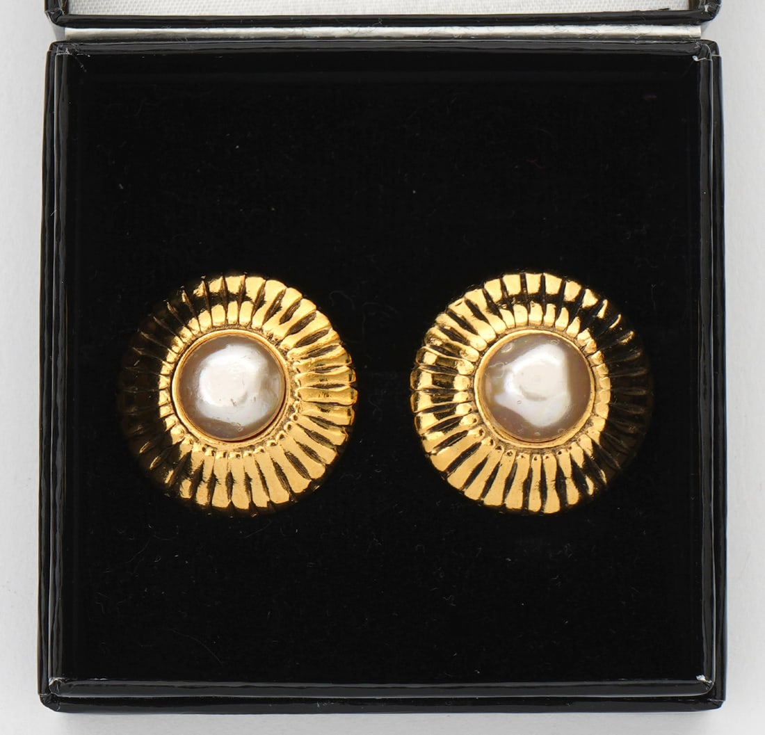 Chanel Faux Pearl Gold Tone Clip-On Earrings: Chanel faux pearl gold tone sunburst-motif clip on earrings, measures 25mm. Condition report: Good condition, no issues, please examine all photos closely. Contact C. Biddle Auction Gallery for more d