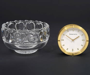 Tiffany & Co Brass Desk Clock & Apple Bowl: Round brass desk clock (3.25"W), Crystal apple bowl (3"H x 5"W), signed underside. Condition report: Good condition, no issues, please examine all photos closely. Contact C. Biddle Auction Gallery for