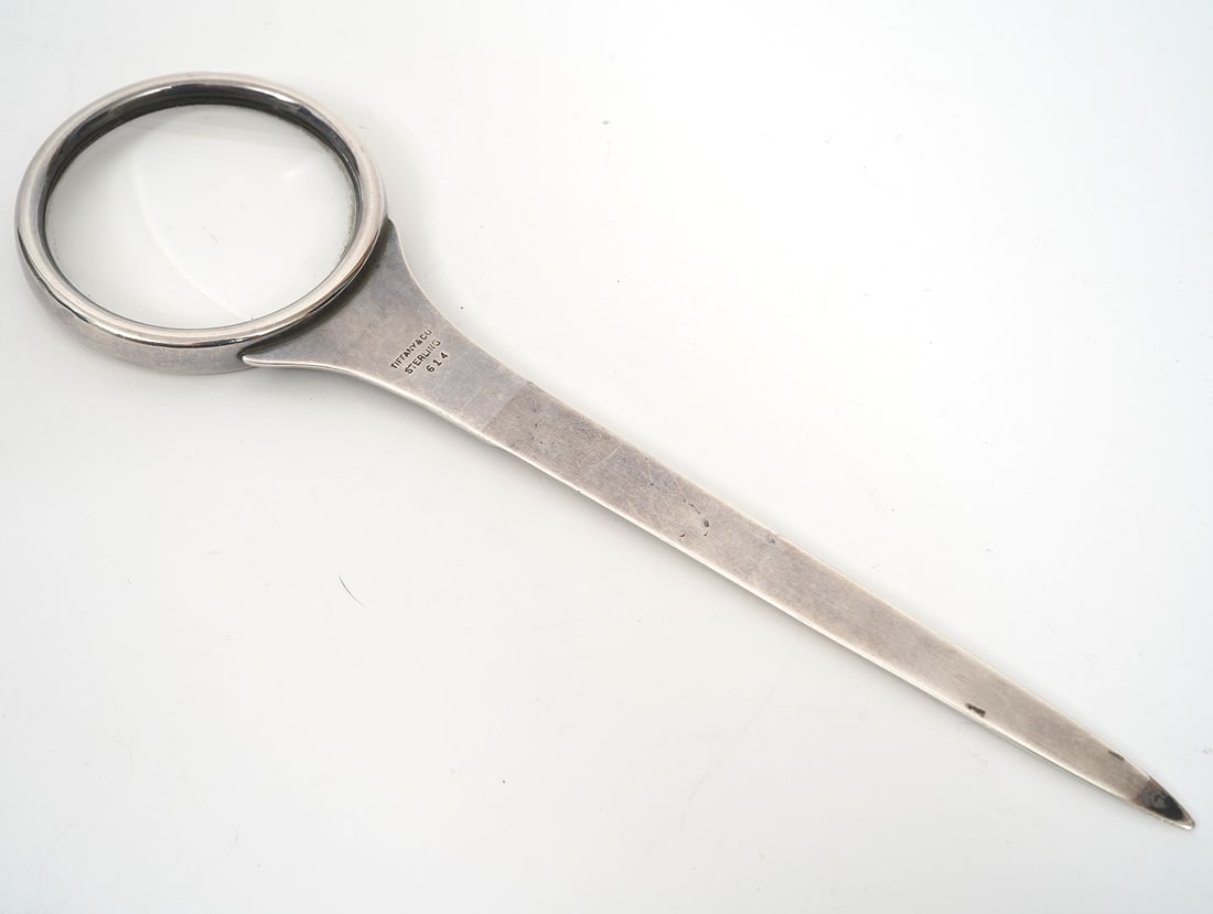 Tiffany & Co Sterling Magnifier & Letter Opener: Tiffany & Co sterling silver magnifier and letter opener, 9" long. Hallmarked on letter opener. Weight - 97g. Condition report: Multiple dents to silver, please examine all photos closely. Contact C. 