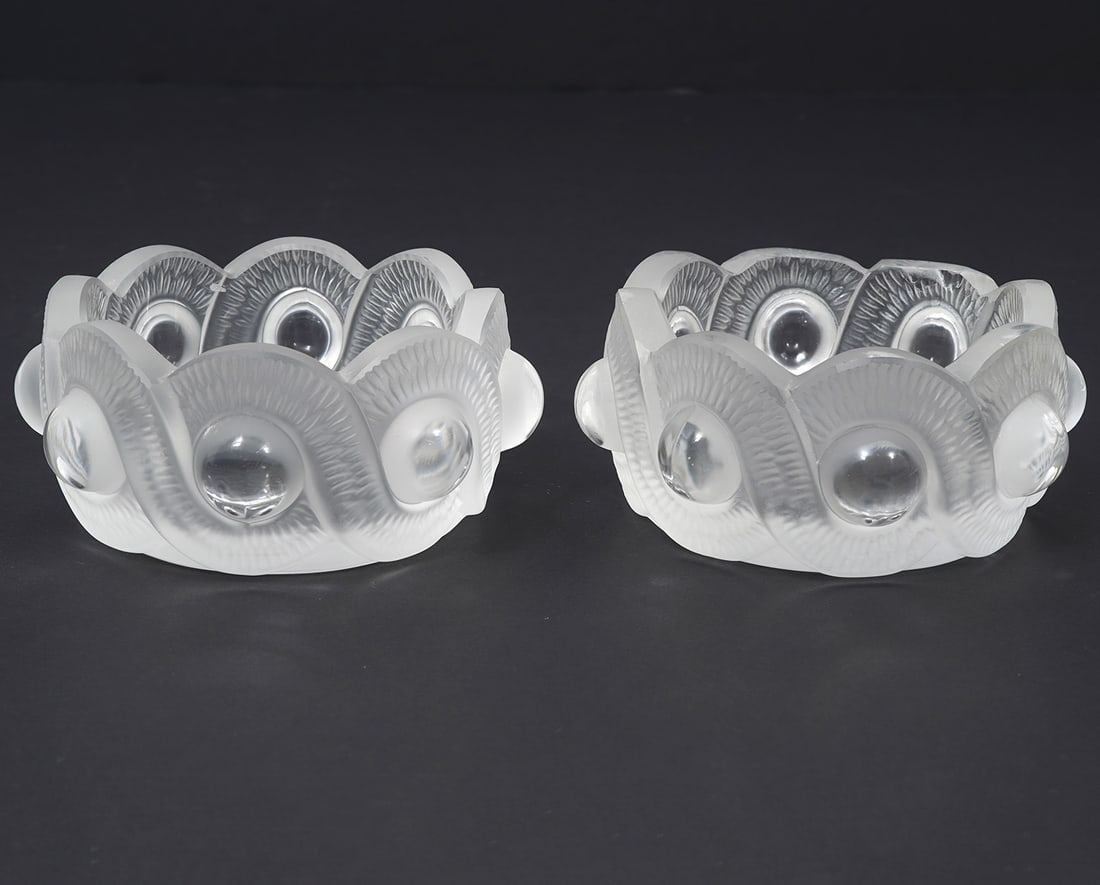 Two Lalique Frosted Crystal "Gao" Bowls: Two Lalique French frosted crystal "Gao" bowls, serpentine style pattern, signed underside. Each measures 2"H x 4.5"W. Condition report: one bowl has chips and some edges smoothed down, please examine