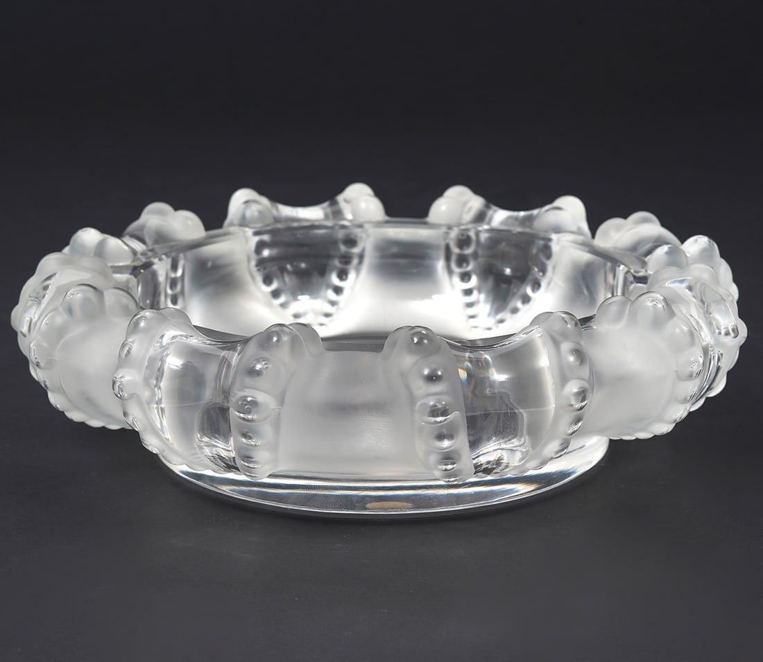 Lalique "Cannes" Frosted Crystal Ashtray: Lalique "Cannes" pattern frosted crystal ashtray features octopus arms motif. Signed underside. Measures 7.5"W. Condition report: Good condition, please examine all photos closely. Contact C. Biddle A