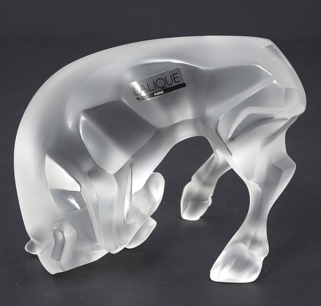 Lalique Auruch Taureau Crystal Bull Figure: Lalique "Auruch Taureau" satin finish crystal bull figure, measures 3.25"W x 5"L x 4.25"H. Condition report: Good condition, please examine all photos closely. Contact C. Biddle Auction Gallery for mo