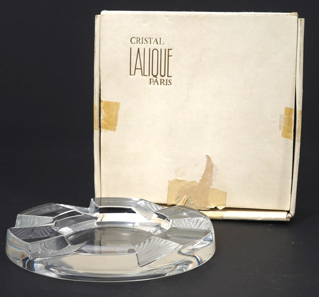 Lalique 'Cuba' Crystal Ashtray: Lalique 'Cuba' crystal ashtray includes original box. Signed underside. Measures 6" wide. Condition report: Good condition, minor scratches underside, please examine all photos closely. Contact C. Bid
