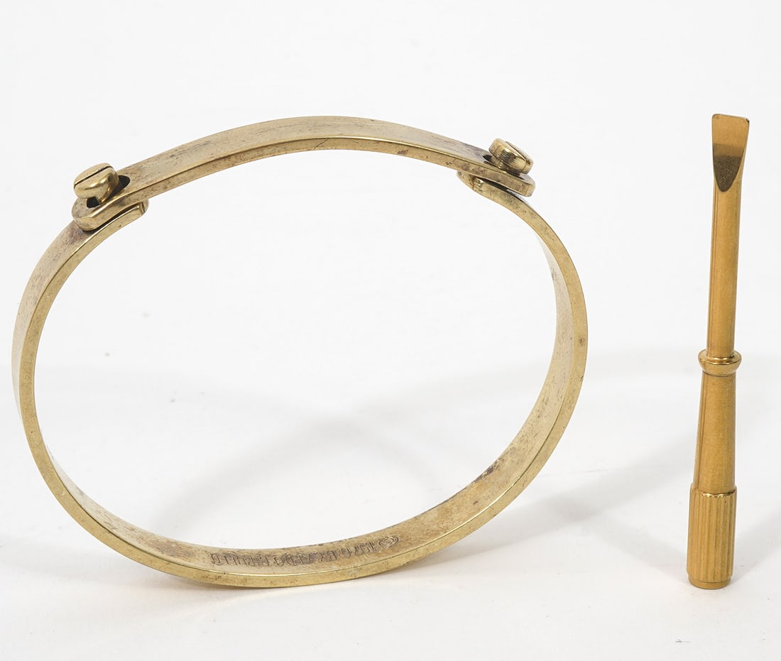 Aldo Cipullo and Charles Revson 1976 Bracelet: Aldo Cipullo and Charles Revson 1976 gold electroplate bangle friendship bracelet with two screws. Includes flat heat screw driver. Approximately 7" inner circumference. Condition report: Good conditi