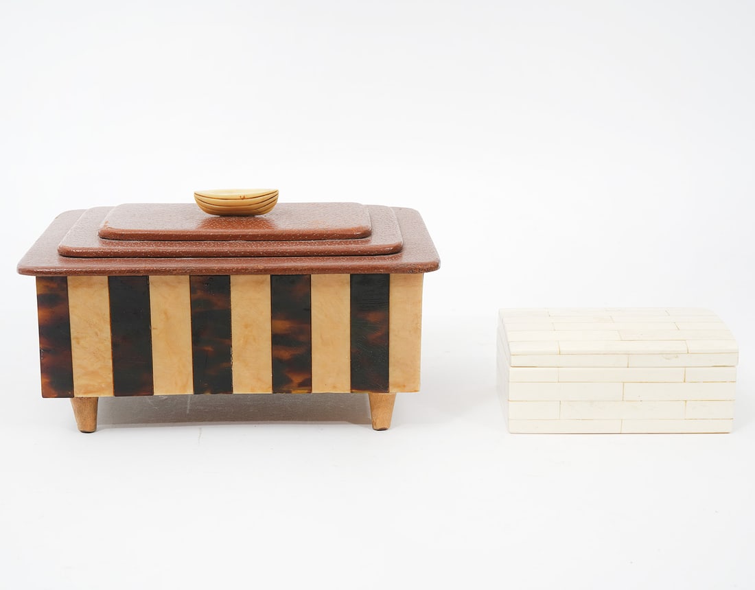 Music Box Leather Top & Tessellated Trinket Box: Music box has leather interior and stepped leather lid with canoe shaped finial, tessalated 2 color body raised on 4 feet. Measures 7.25"L x 5"W x 4"H. Condition: music box is working, very light surf