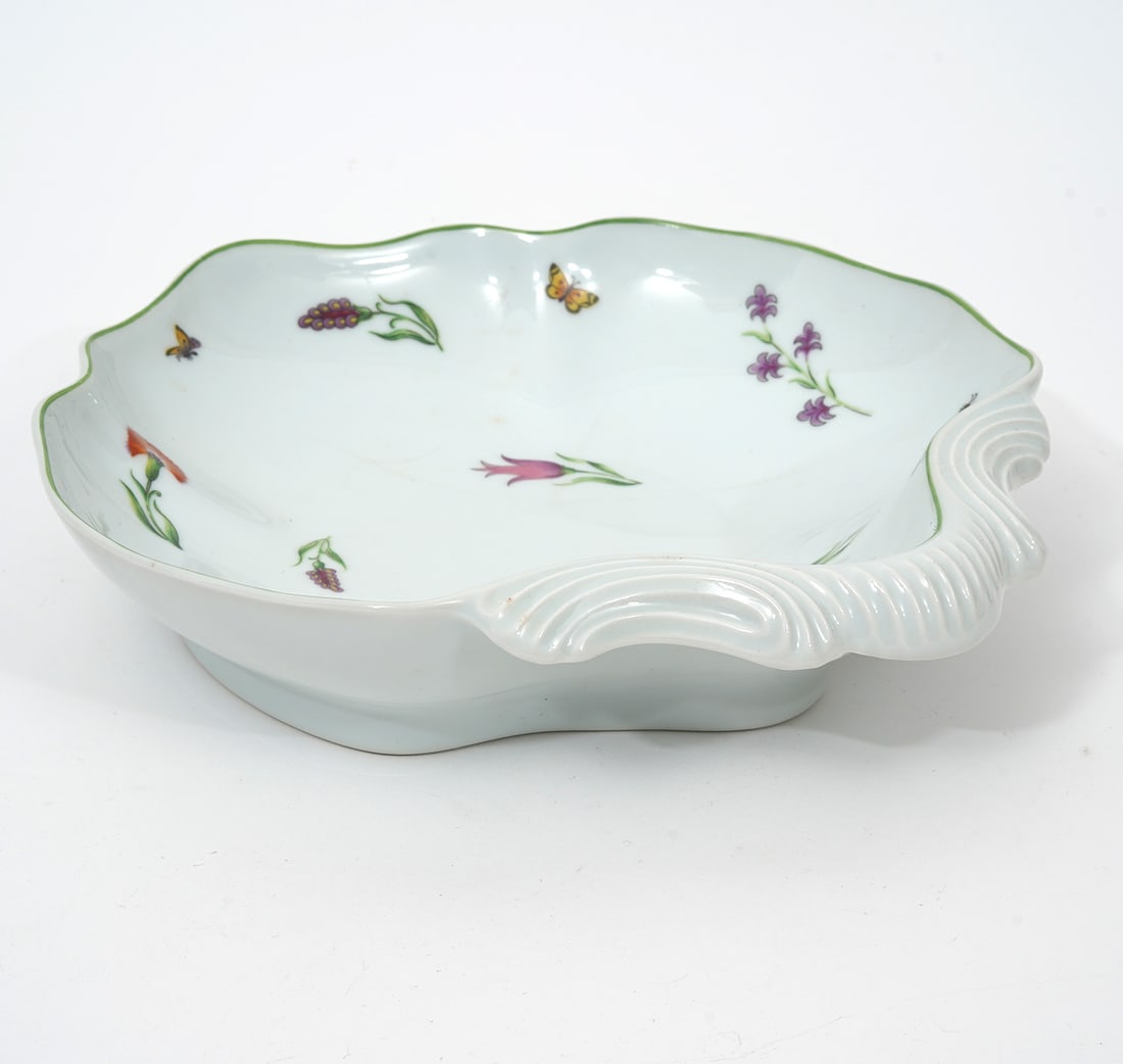 Tiffany & Co Limoges "Tiffany Garden" Bowl: Tiffany & Co French Limoges "Tiffany Garden" fruit bowl, decorated on inside with flowers and butterflies. Hallmarked underside. Measures 9"H x 8.5"W. Condition report: Hairline cracks underside, plea