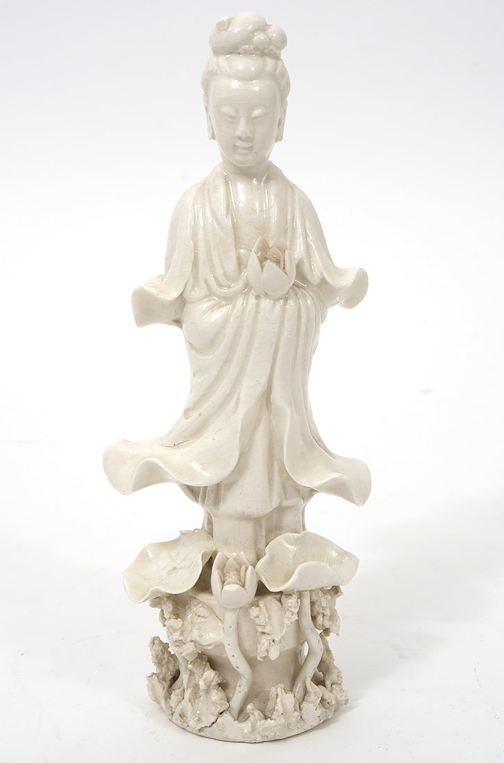 Small Chinese Blanc de Chine Guan Yin Figure: Small black de chine porcelain figure of Guan Yin holding a flower. Measures 7.25"H x 2.5"W. Condition report: Minor chip to head, please examine all photos closely. Contact C. Biddle Auction Gallery 