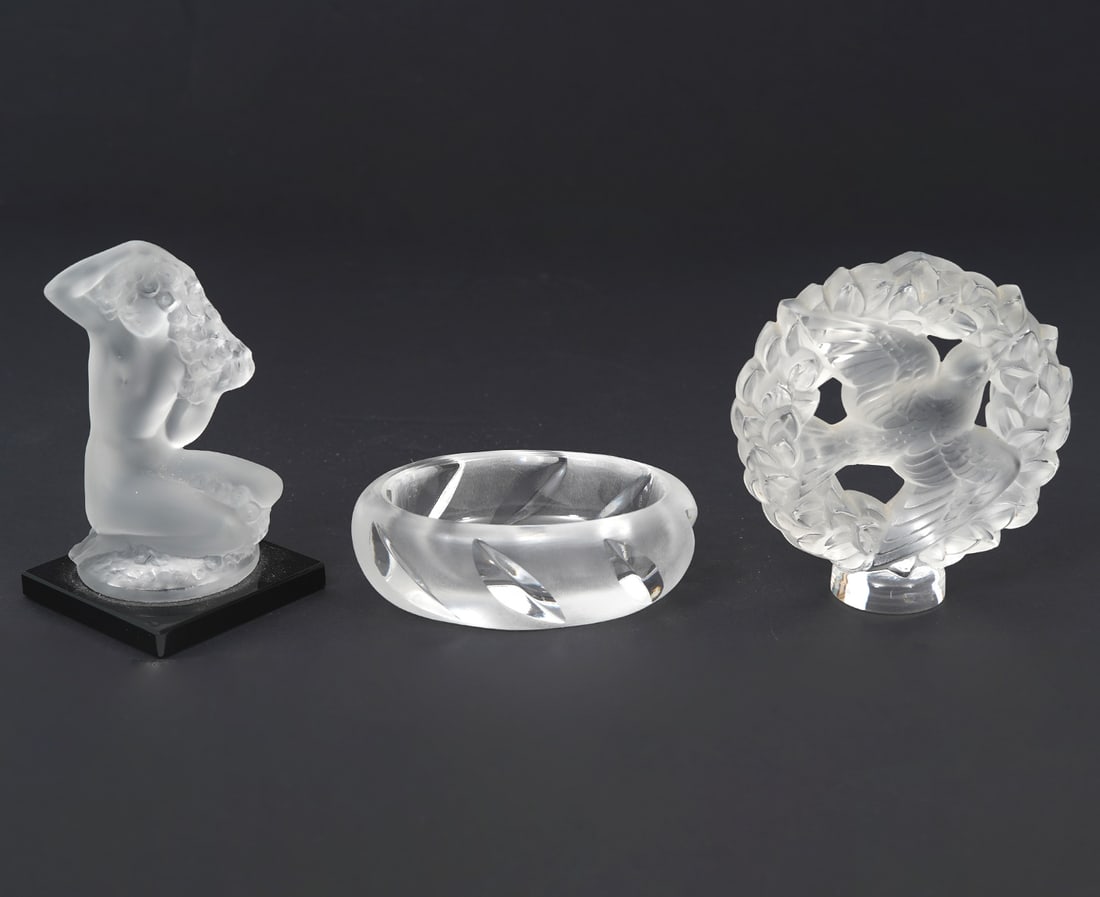 3 Piece Lalique Crystal Group: 3 Piece group of Lalique crystal includes: Female nude statuette on black platform ( 2" x 2" x 3.25"); Bird in wreath (3"H x 3"W); Small frosted cut to clear dish (3"L x 2.25"W x 1"H). Each signed. Co