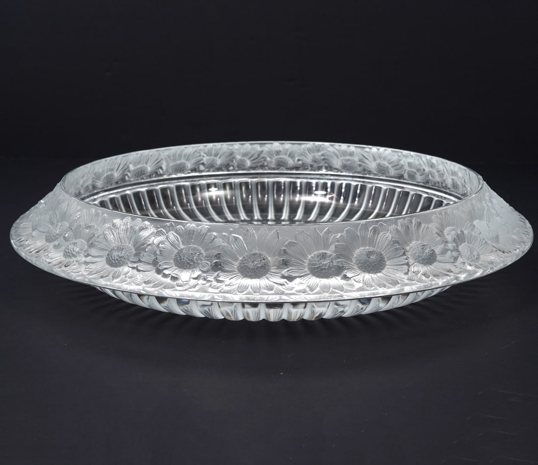 Lalique Crystal Marguerites Bowl: Originally designed by Rene Lalique in 1941, showing his passion for daisies in the detailed rim. The bowl is frosted and clear and has a ribbed base. Signed on underside 'Lalique France'. Measures 2.