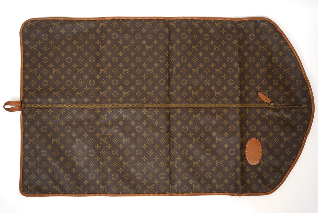 Louis Vuitton Garment Bag: Louis Vuitton garment bag, measures 39"L x 23.5"W. Good condition, minor wear to edges. Please examine all photos closely. Contact C. Biddle Auction Gallery for more detailed information. C. Biddle Au