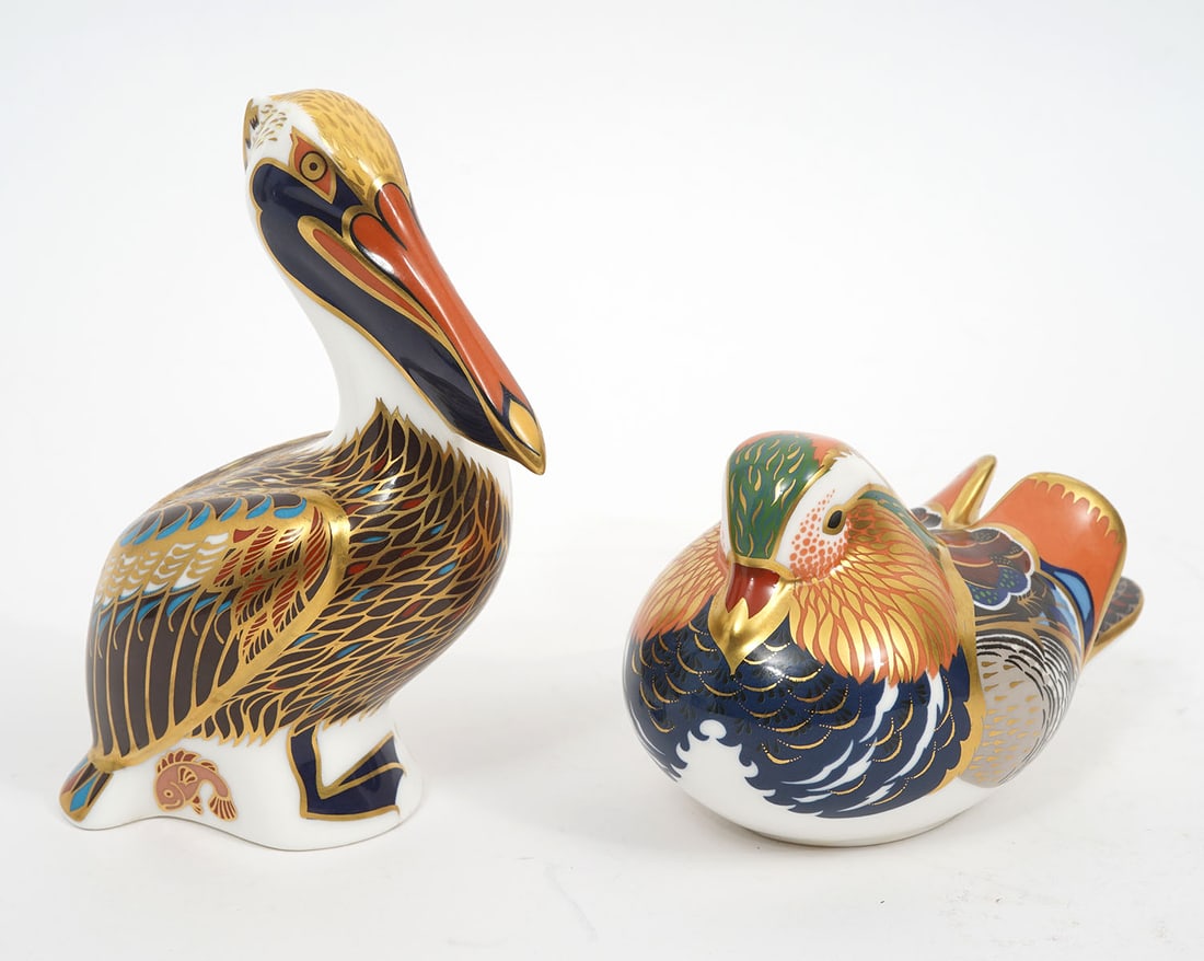 2 Royal Crown Derby Imari Paperweight Figurines: Royal Crown Derby 'Brown Pelican' by John Ablitt has 24 K gold detailing, with gold stopper on bottom, 'Made in England 1998'. Measures 5 1/8"H x 3.5"L x 2.25"W. Royal Crown Derby Imari Mallard has 24