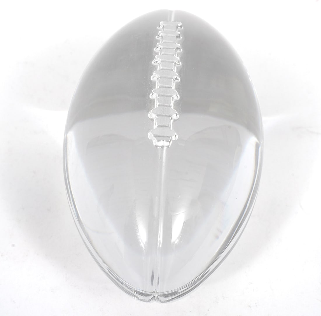 Tiffany & Co Crystal Football Paperweight: Tiffany & Co crystal football paperweight (4.5"L x 2.5"W x 2.25"H). Acid etched mark underside. Condition report: Good condition, please examine all photos closely. Contact C. Biddle Auction Gallery f