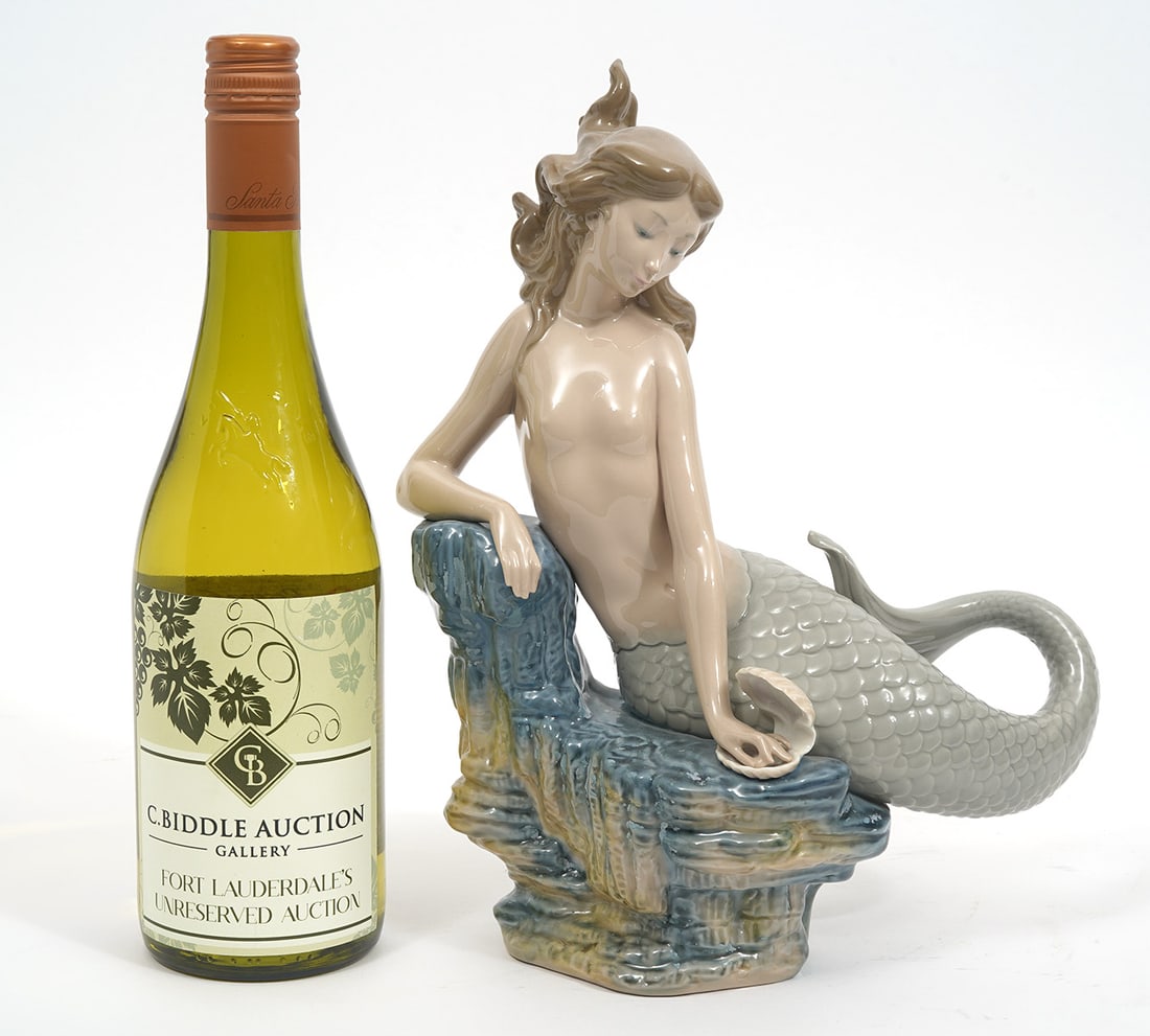 Lladro "Pearl Mermaid" Porcelain Sculpture: Lladro "Pearl Mermaid" porcelain sculpture #1348. Measures 11.5"L x 9.5"W. Hallmarked underside. Condition report: Good condition, please examine all photos closely. Contact C. Biddle Auction Gallery 
