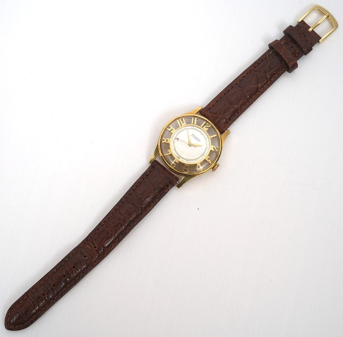 Bucherer 18K Gold Skeleton Antimagnetic Watch: Bucherer Swiss 18K Gold Skeleton Antimagnetic watch, circa 1960, features front and back skeleton casings with arabic numerals. Approx. 30mm. Swiss hallmark on back and after market leather band. Cond