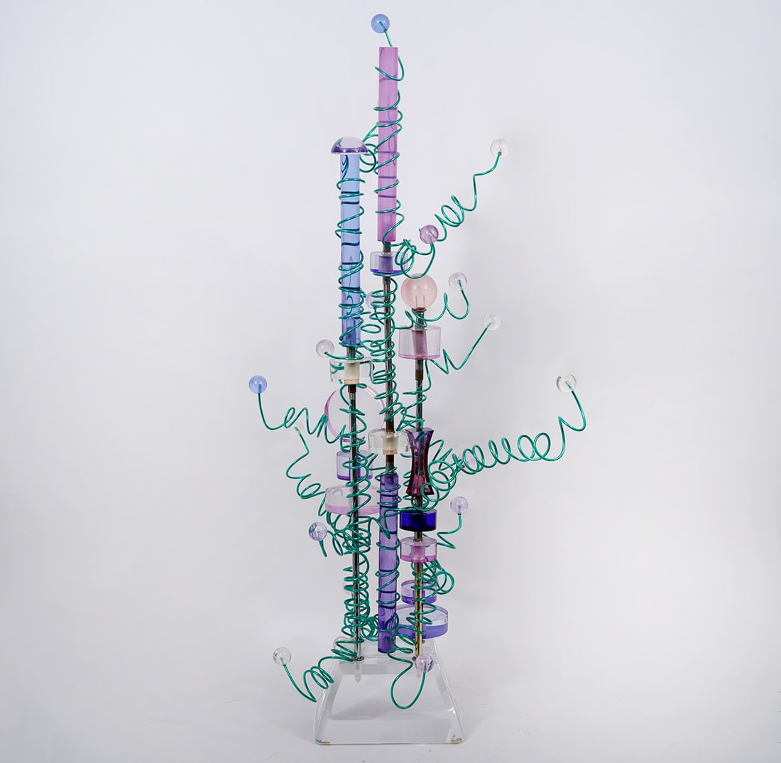 Whimsical Colored Lucite & Wire Sculpture: Whimsical lucite sculpture in blue, purple, pink, lilac and clear lucite with random curly cue green wire extensions. Sculpture is mounted on clear base with beveled edges and illegible signature, dat