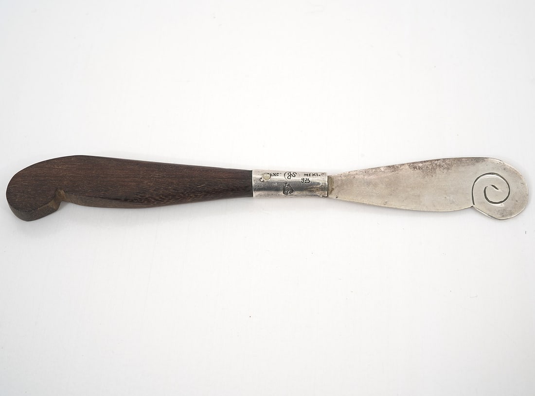 Bernice Godspeed Aztec Sterling Rosewood Spreader: Bernice Godspeed "Aztec" sterling silver with rosewood handle butter spreader. Measures 6" long. Hallmarked on collar. Condition report: Good condition, common wear for age and use, please see all pho