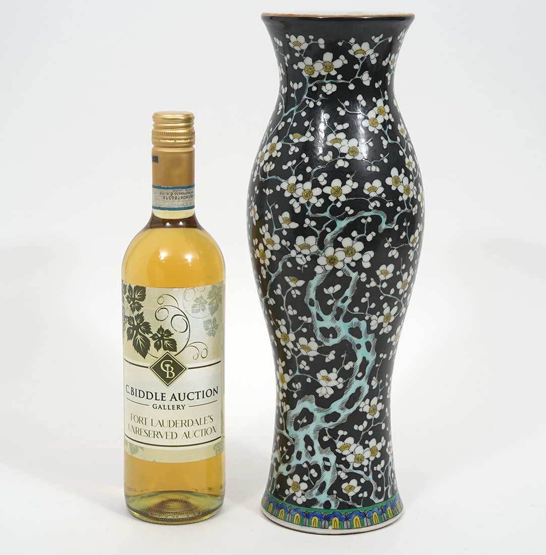 Chinese Porcelain Floral Vase: Chinese porcelain vase featuring cherry blossom pattern over black ground. Blue ring underside vase. Measures 14.5"H x 4.5"W. Condition report: Good condition, please examine all photos closely. Conta
