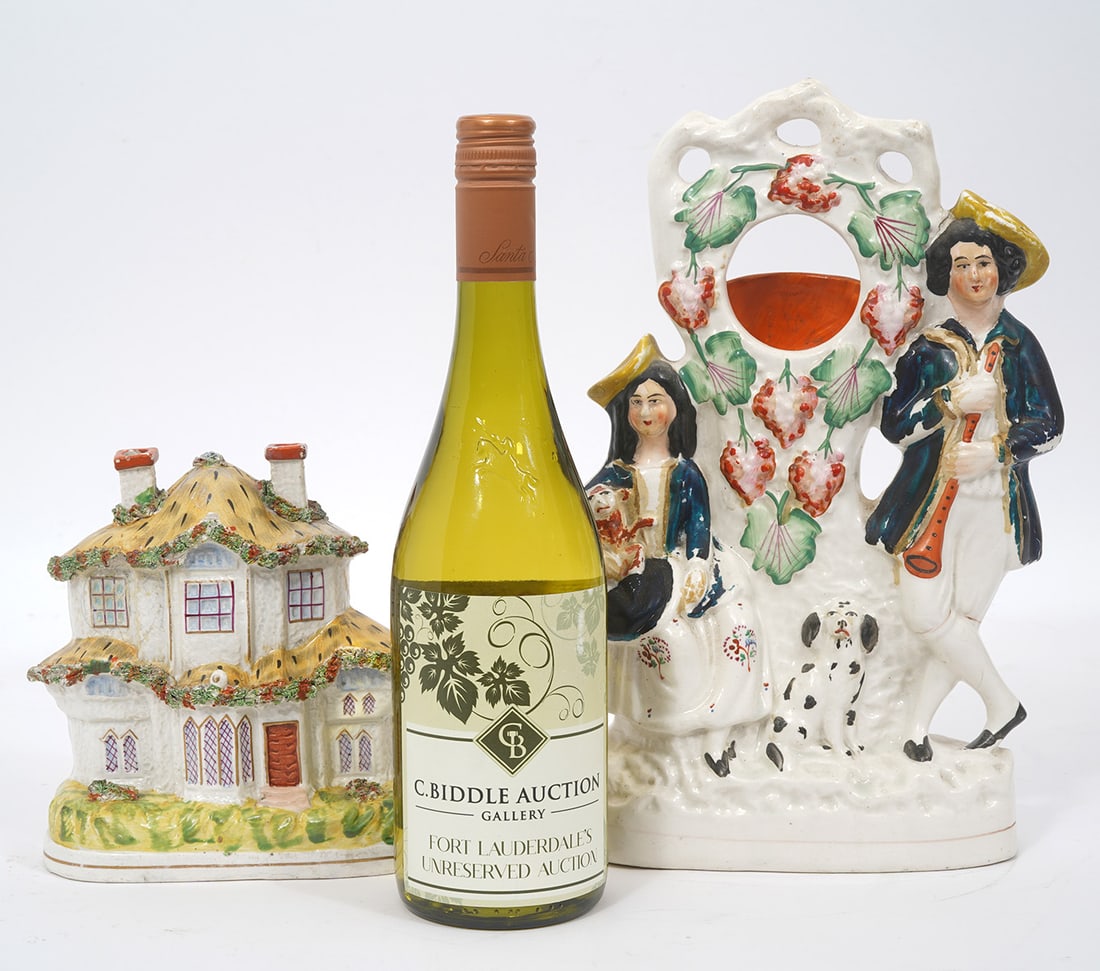 Two Staffordshire Porcelain Figures: Two Staffordshire porcelain figures includes Couple with two dogs (12.5"H x 7.5"W x 2.5 "D ), and English country home (7"H x 6"W x 2"D). Condition report: Minor losses throughout, please examine all