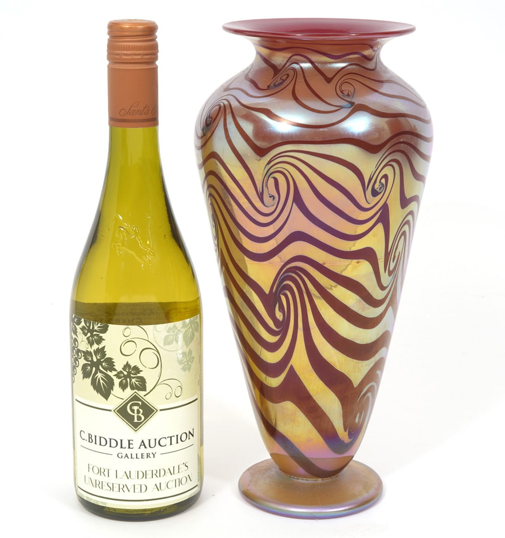 Molly Stone Iridescent Swirl Art Glass Vase: Molly Stone iridescent art glass vase, features gold and red swirl pattern with tapered body and flared rim. Signed underside, dated 1998. Measures 11.5"H x 5.5"W. Condition report: Good condition, pl