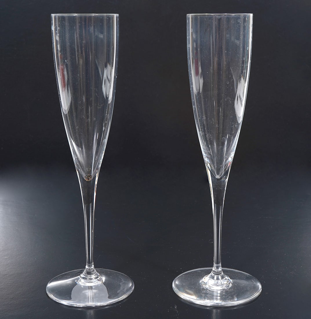 Pair of Baccarat Champagne Flutes: Pair of Baccarat France crystal champagne flutes in original red box (missing lid). Each measures 9". Condition report: Good condition, please see all photos. Contact C. Biddle Auction Gallery for mor