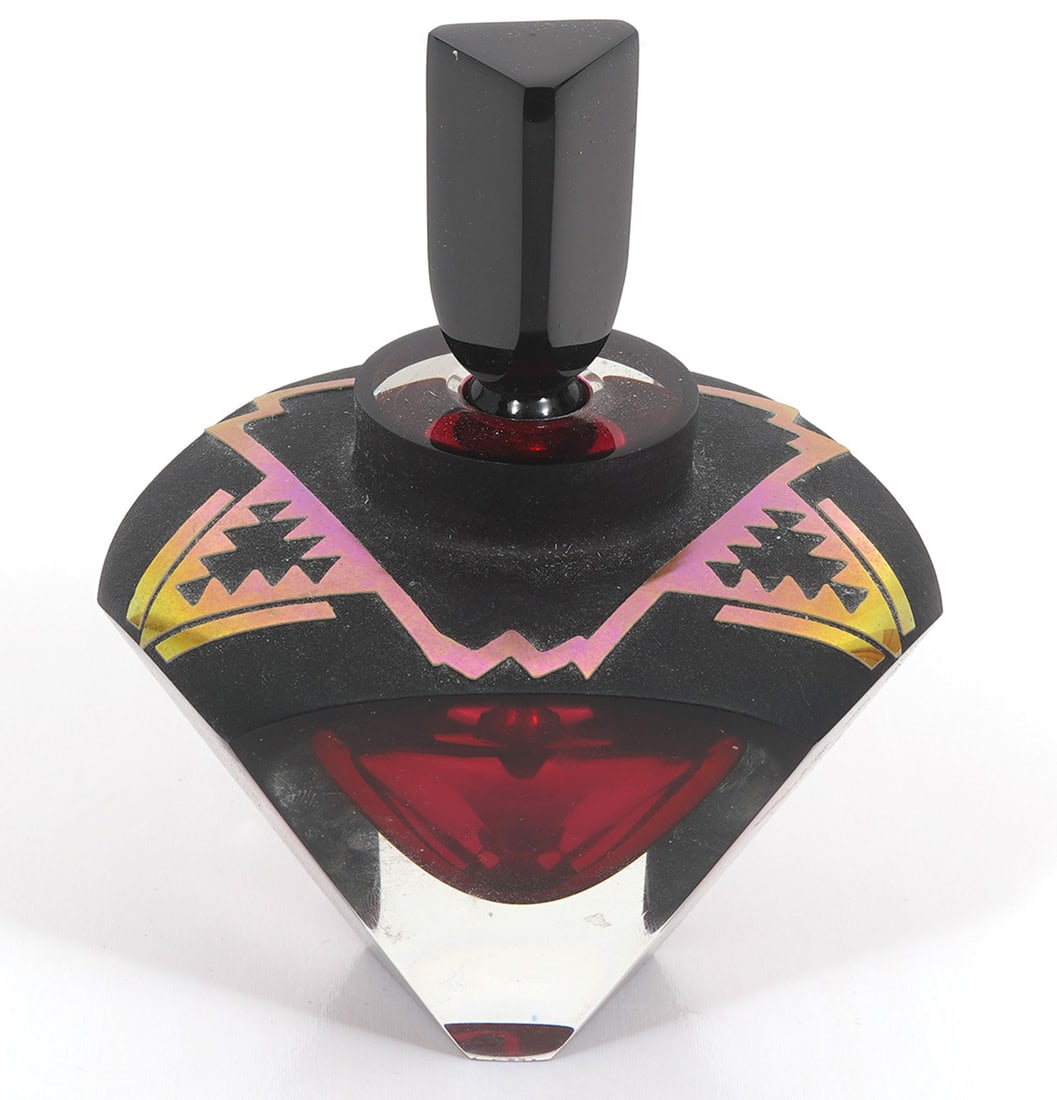 Correia Limited Edition Art Glass Perfume Bottle: Correia Limited Edition art glass perfume bottle numbered 54/250. Tapered prismatic form, clear with red interior, matte geometric pattern on top and triangular stopper, signed underside. Measures 5"H
