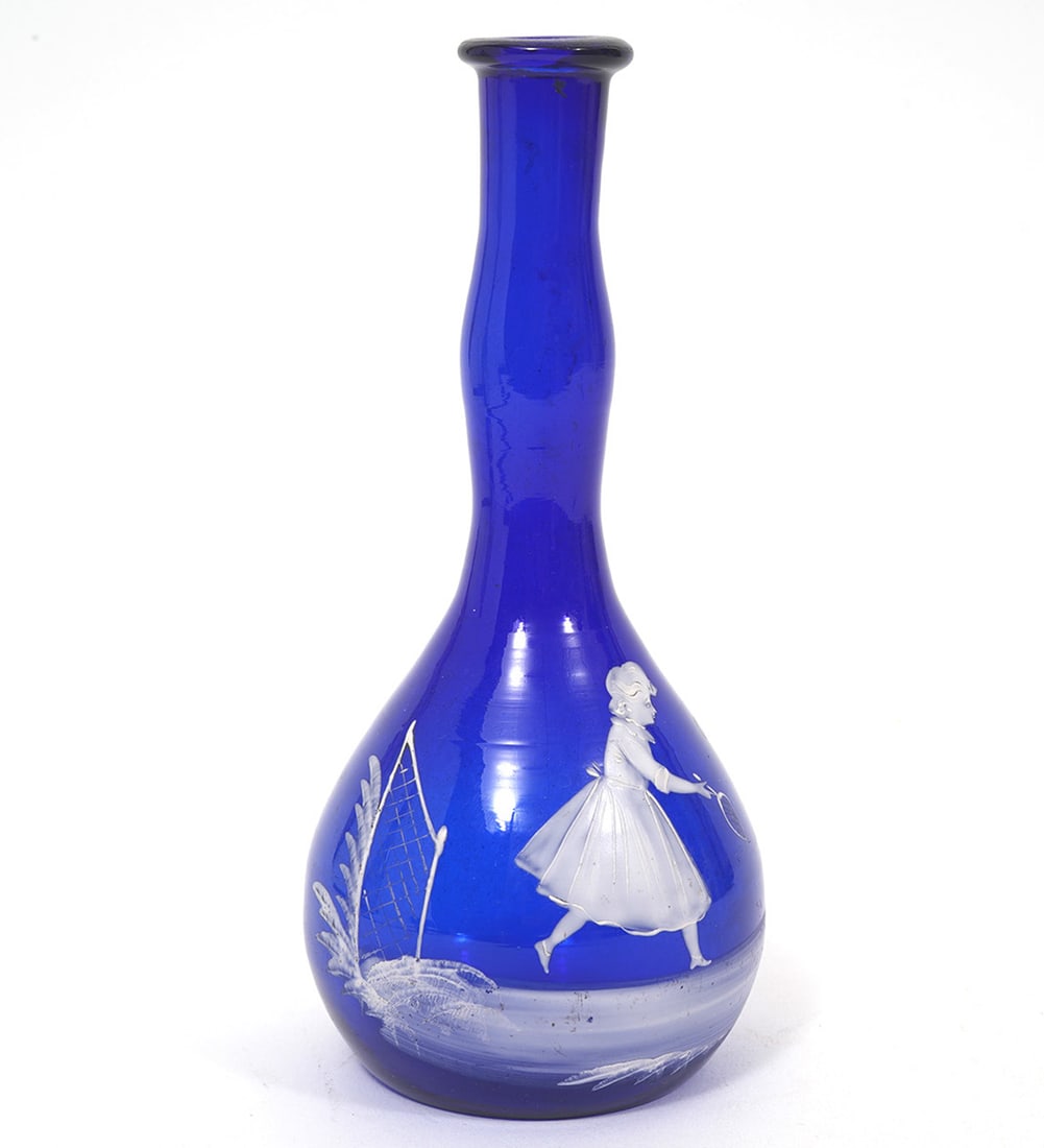 Mary Gregory Cobalt Blue Barber's Bottle: Mary Gregory cobalt blue barber's bottle features enamel scenes of a woman playing badminton or tennis. Measures 8"H x 3.5"W. Condition report: Good condition, please examine all photos closely. Conta