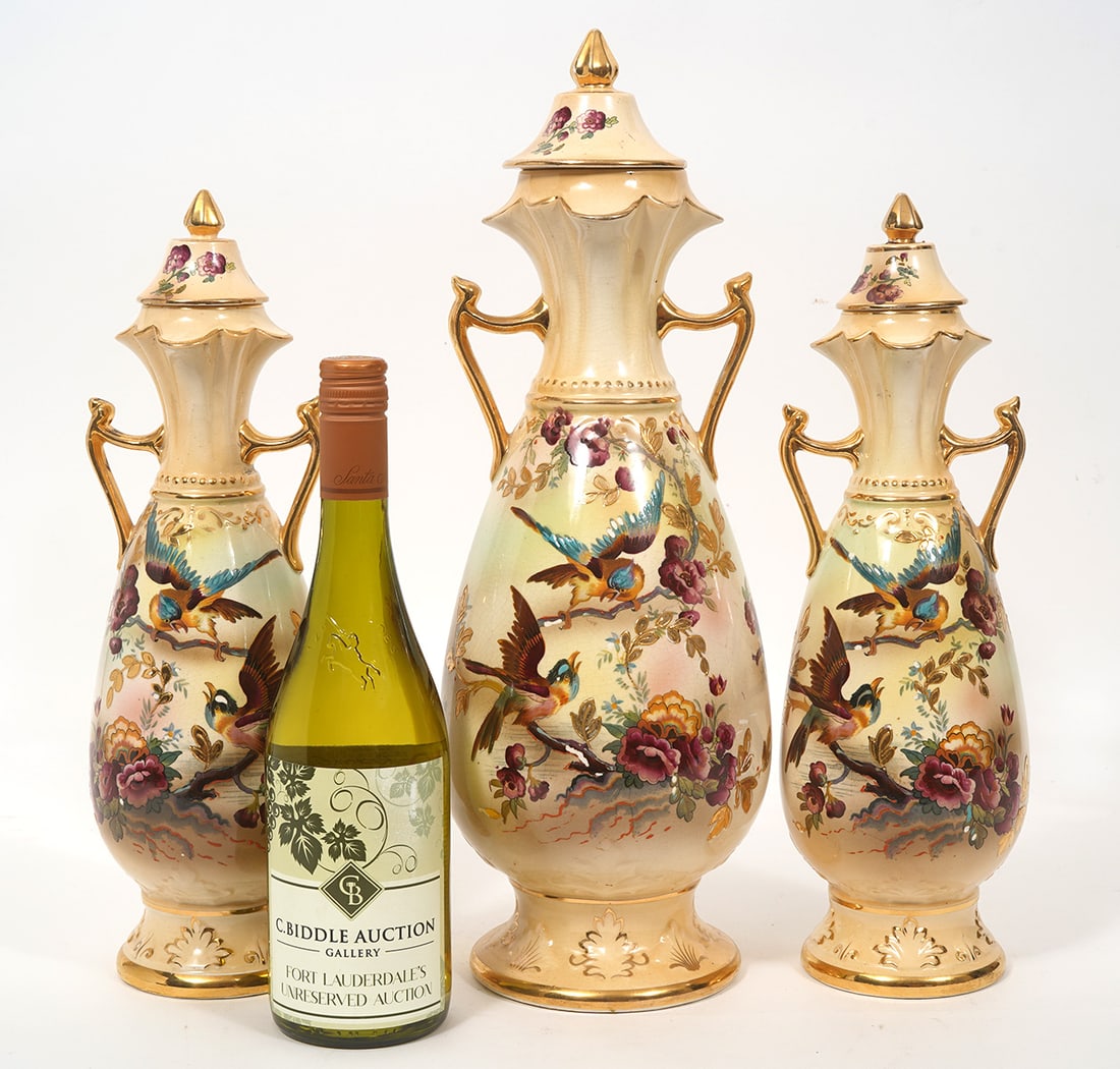 3 Pieces English Porcelain Painted Urns: 3 piece group of English hand-painted porcelain urns, decoration features birds and flowers, gilt accents.. Measurements: 2 smaller urns- 14.5"H x 4.5"W, larger - 17.5"H x 6"W. Condition report: Minor