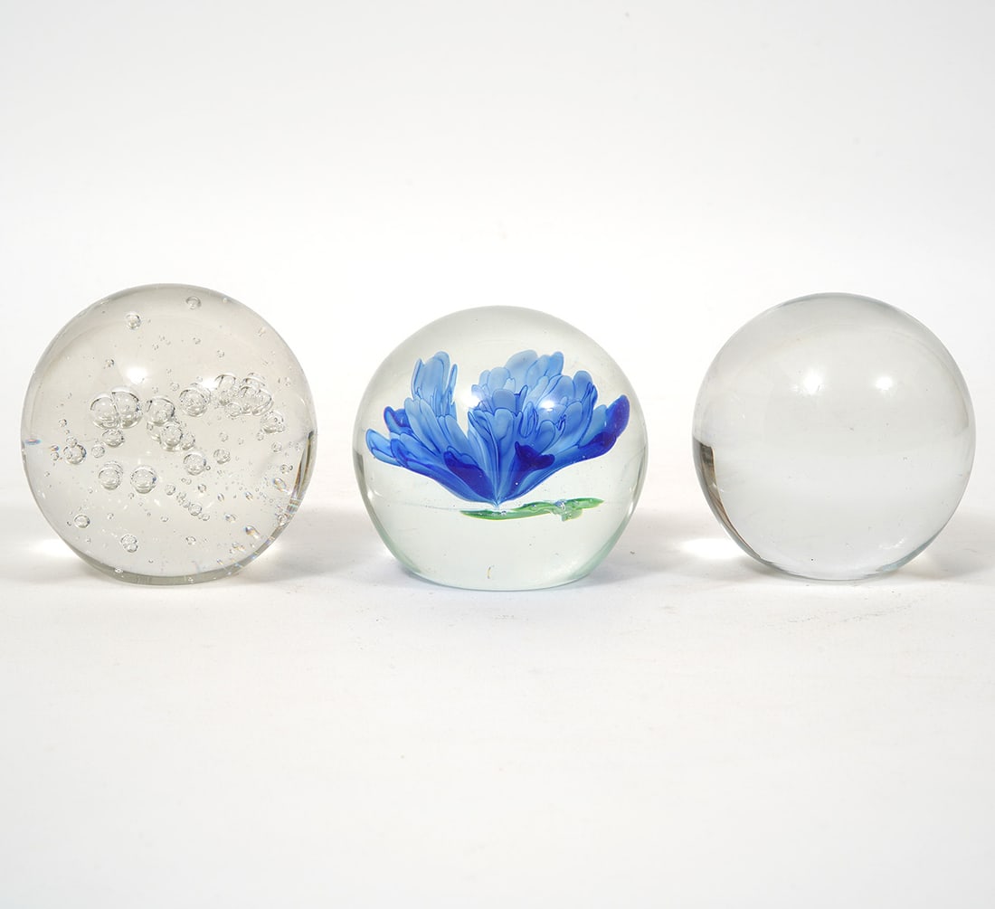 Group of Three Art Glass Paperweights: Group of three art glass paperweights, includes suspended bubble and blue flower designs. Each measures approx 3" in diameter. Condition report: Good condition, please examine all photos closely. Cont