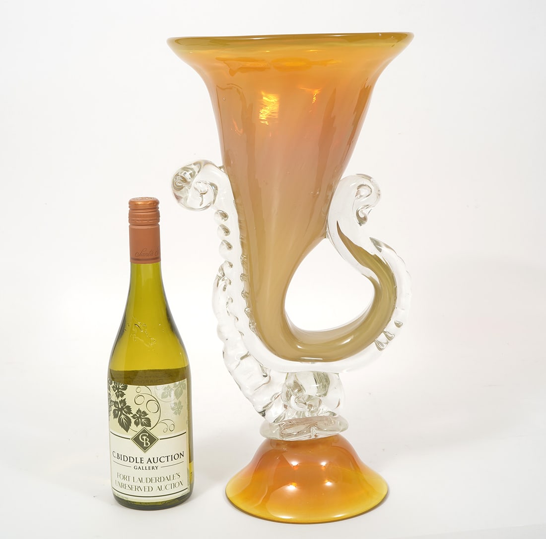 Murano Italian Hand-Blown Art Glass Vase: Murano Italian hand-blown art glass vase features a trumpet form with clear and opaque yellow-orange color. Measures 18"H x 9.5"W. Condition report: Good condition, minor scratches at foot, please exa