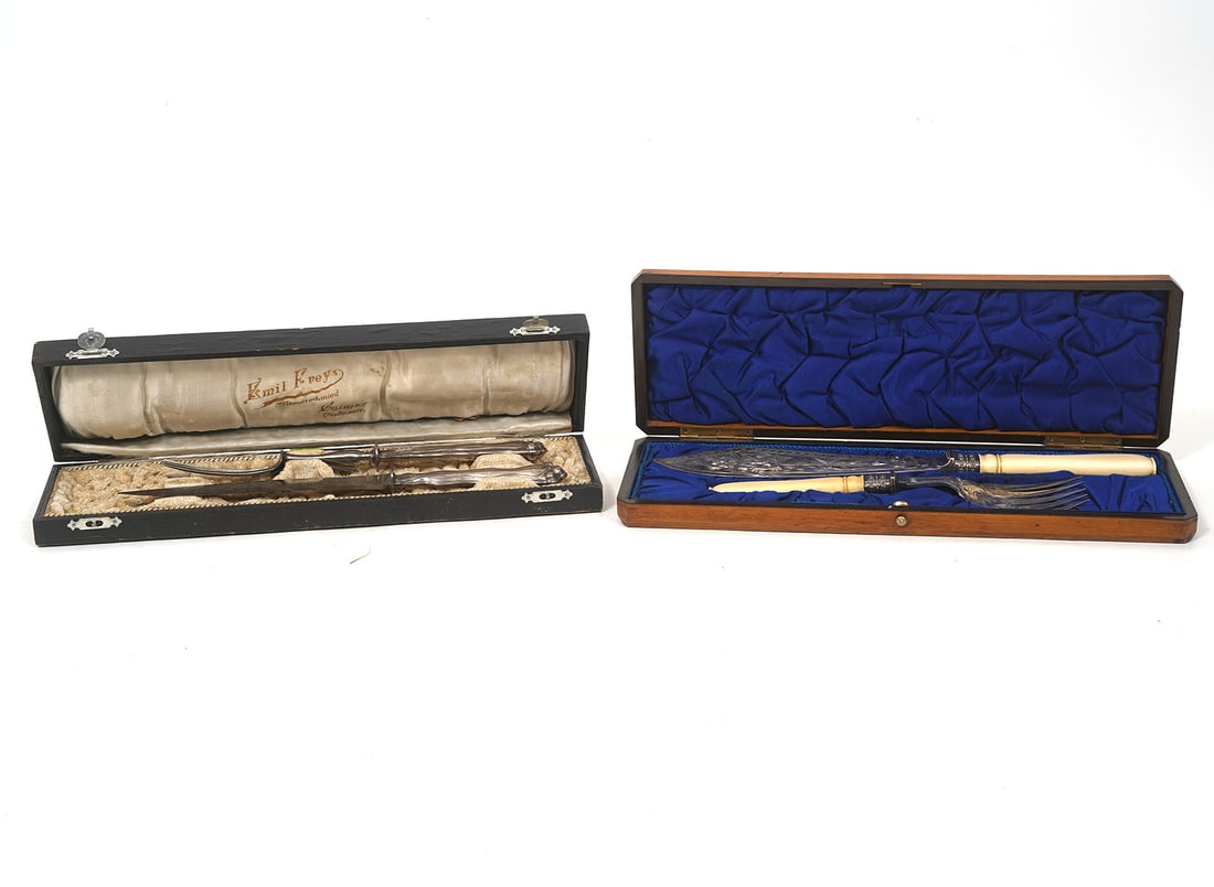 Two Silverplate Carving Sets in Custom Boxes: Silverplate fishing fork and knife with bone handles in custom wood case. The silverplate is engraved with decorative designs on both pieces. Fork measures 9.25"L; knife 11 3/8"L; wood case 14"L x 5"W