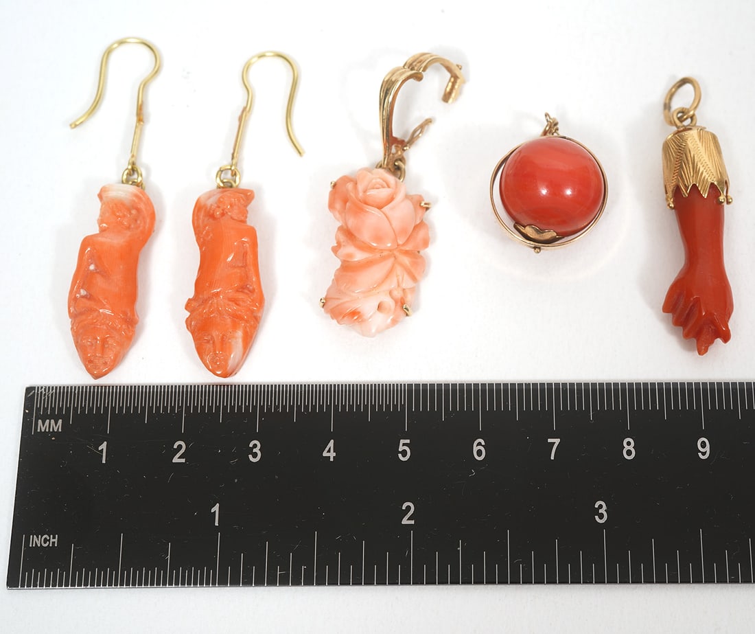 Five Pieces of Coral and Gold Jewelry: Five pieces of coral and gold jewelry includes floral carved pendant (1.5"L x .5"W); coral pierced hanging earrings (2"L x 3/8"W); ball shaped pendant (3/8"L x 3/8"W); figa pendant (1.5"L x .25"W). Co