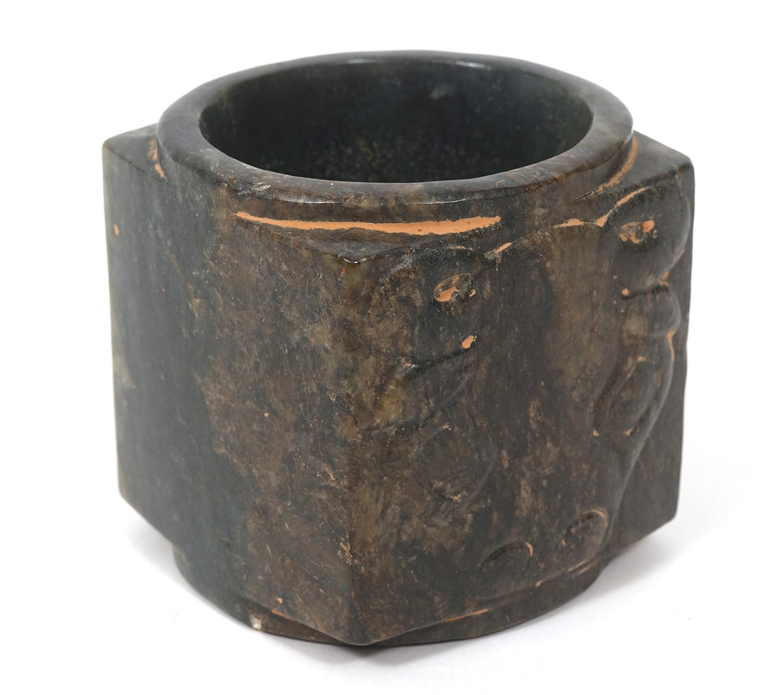 Carved Mottled Green Jade Cong: The jade cong has a square outer section and a hollow circular inside. Each corner serves as a vertical axis over which a symmetrical mask motif is carved. Used at times during sacrificial and burial 