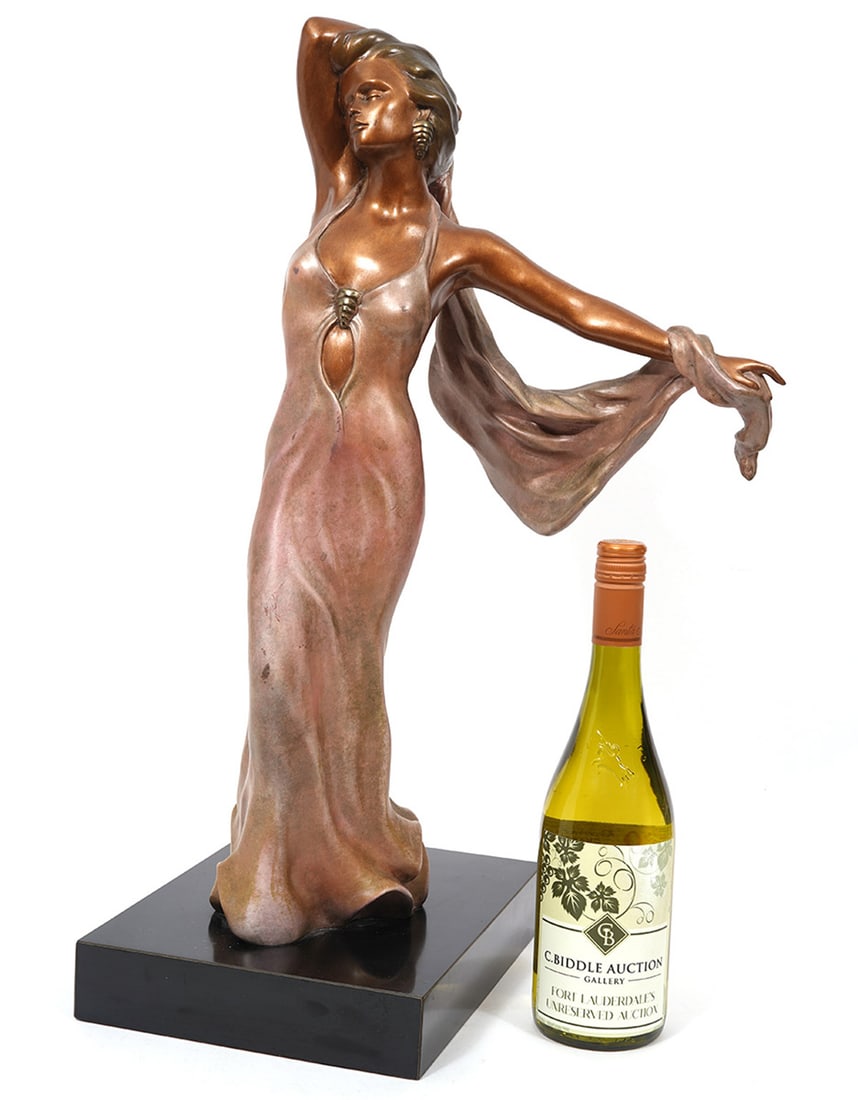 Alice Riordan Mounted Brass Sculpture: Alice Riordan, American (20th C). Gold-rose bronze sculpture of a woman in an evening gown with a flowing scarf is mounted on a black rectangular plinth. The sculpture is signed on the bottom edge of
