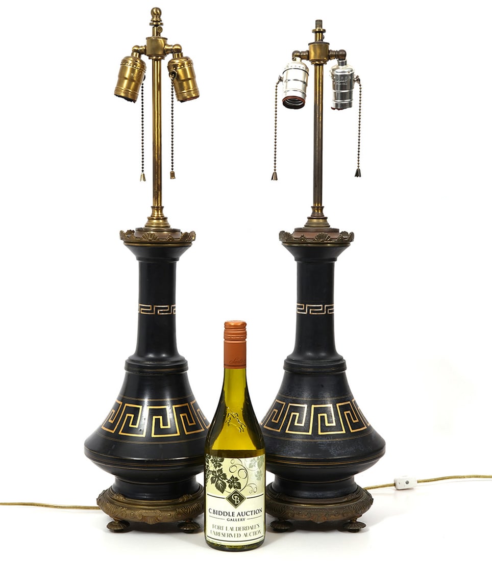 Pair of Neo-Classical Greek Key Bronze Lamps: Pair of Neo-Classical Greek key bronze lamps decorated in black and gold with four footed bases. Measures 28"H x 7.5"W. Condition report: Some surface wear throughout, please examine all photos closel