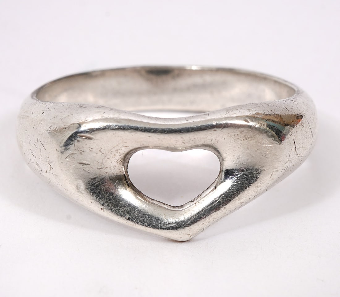 Tiffany & Co Elsa Peretti Heart Ring Size 5.5: Elsa Peretti for Tiffany & Co "Heart" ring size 5.5 and is signed on inside. Weight 3.5g. Condition report: Good condition, please examine all photos closely. Contact C. Biddle Auction Gallery for mor