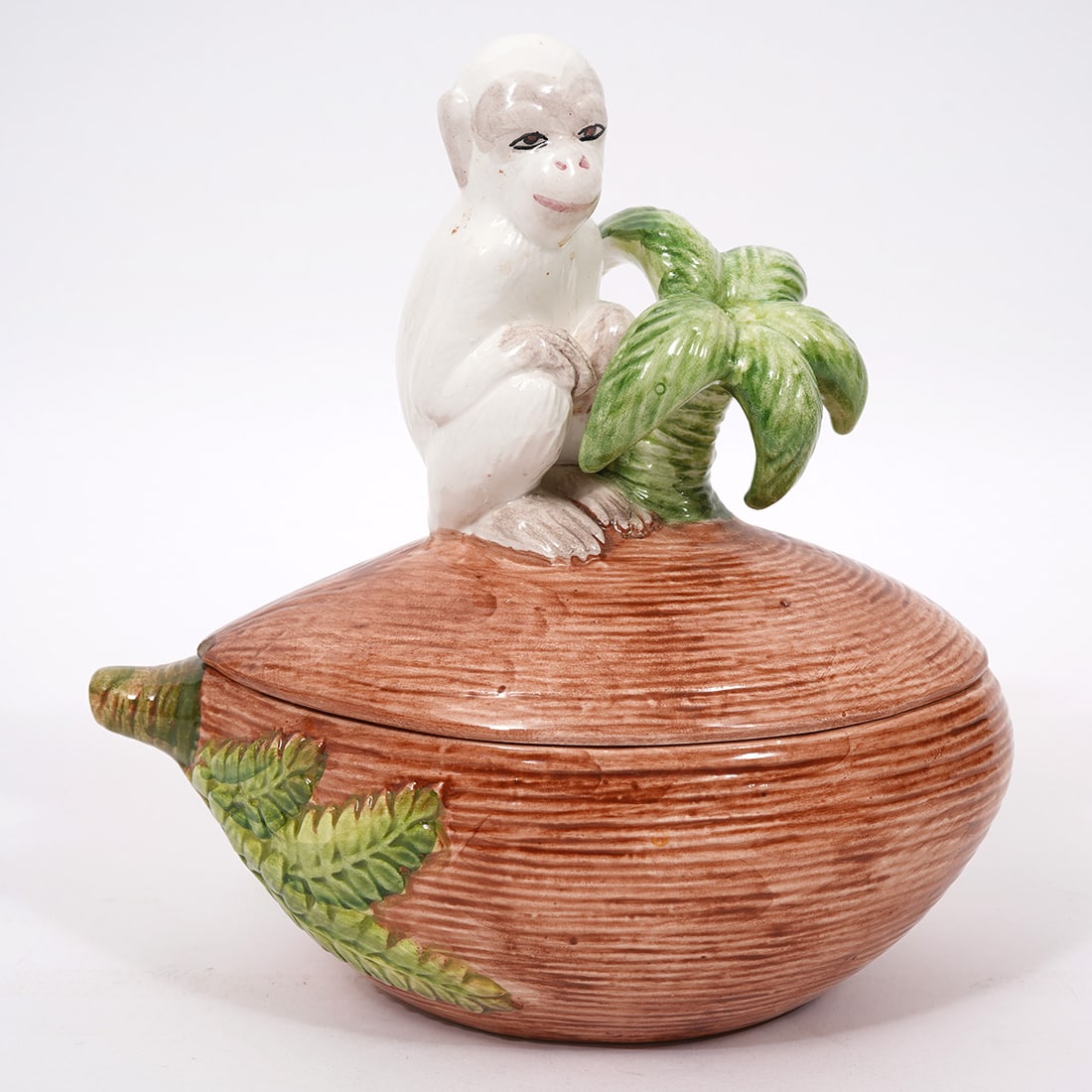 Vetri Italian Porcelain Monkey & Coconut Box: Vetri Italian porcelain box composed of a coconut with a monkey and palm tree. Measures 8"H x 8"W. Condition report: Good condition, please examine all photos closely. Contact C. Biddle Auction Galler