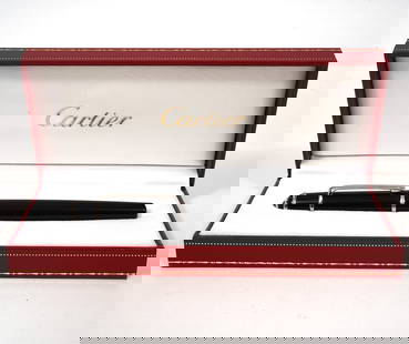 Cartier Diabolo Ballpoint Pen: Cartier Diabolo ballpoint pen model #ST180003 in black with gold accents and engraved with Cartier trademark on clip. Comes in original box with certificate of guarantee and booklet. Measures 5.5"L
