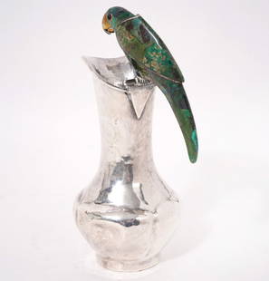 Emilia Castillo Malachite & Silverplate Pitcher: Emilia Castillo, Mexico (Born 1958). Silverplate pitcher with hammered finish stamped 'Los Castillo', serial number 383 and has a malachite handle formed as a parrot. Measures 6.5"H (8"H with parrot)